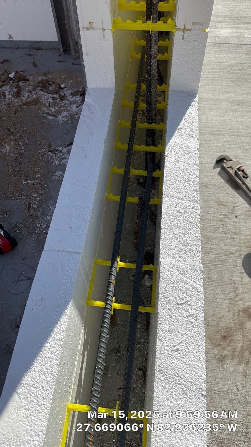 Construction workers installing wooden wall framing on a residential project.