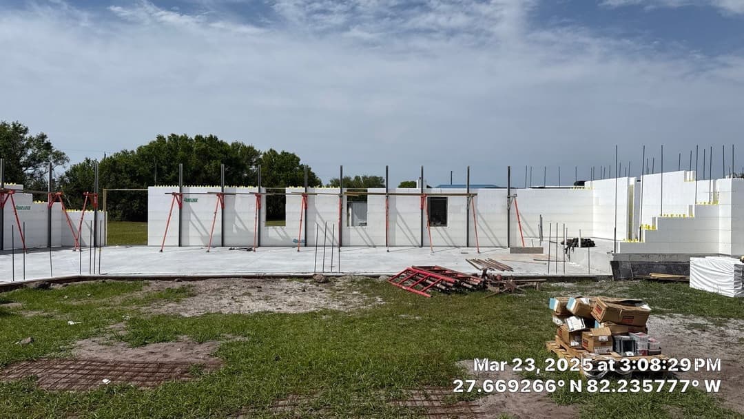 A construction crew assembling the structural framing of a multi-story building.