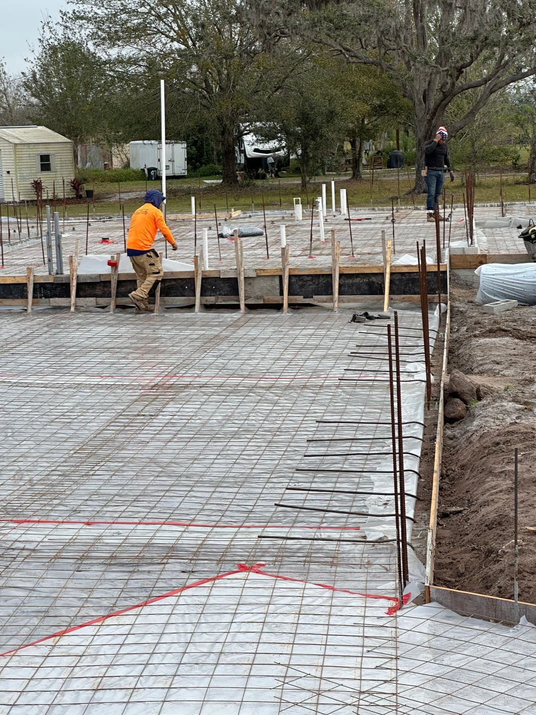 A construction crew assembling the structural framing of a multi-story building.